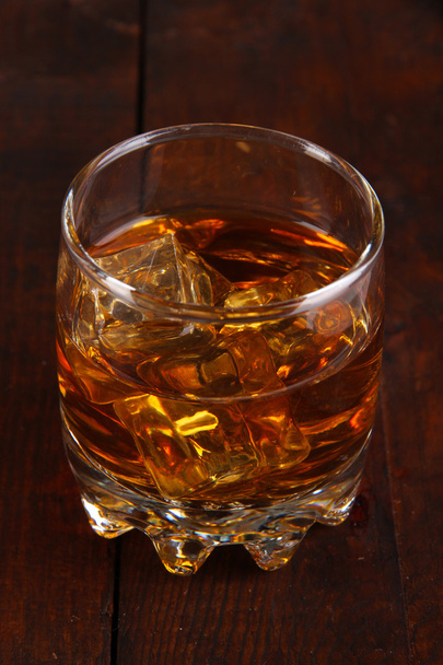 Brandy glass with ice on wooden background - Fotografie, Obrázek