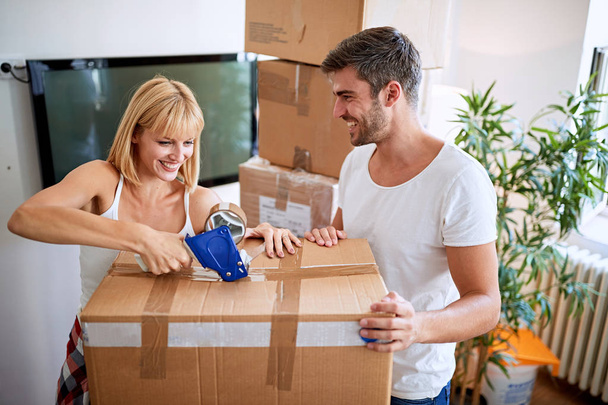 Couple move to new apartment and unpack boxe - Foto, imagen