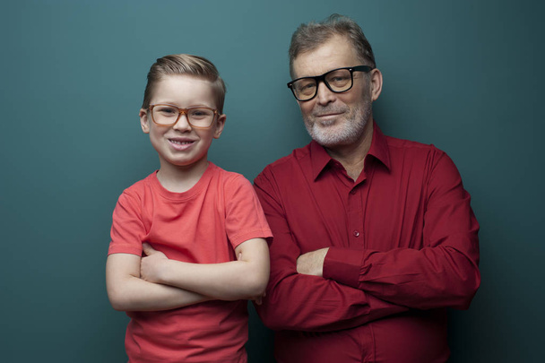 Portrait of positive cute grandfather and grandson - Foto, afbeelding