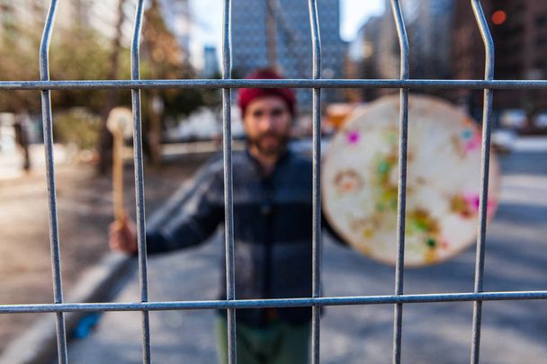 Spiritual man holds native drum downtown - Photo, Image