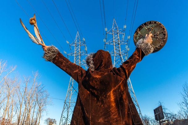 Sacred man beneath electricity towers - Photo, Image
