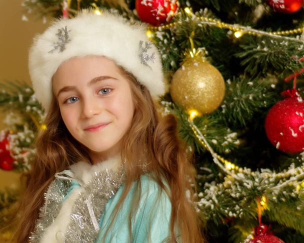 Little girl Snow Maiden near the New Year tree. - 写真・画像