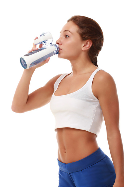 Young attractive fitness model drinking - Zdjęcie, obraz