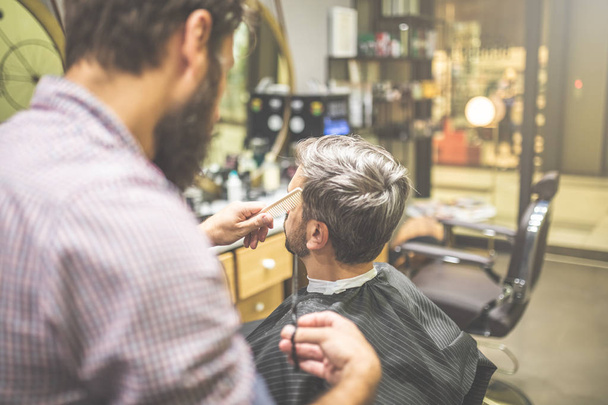 Male client getting haircut by hairdresser - Fotoğraf, Görsel