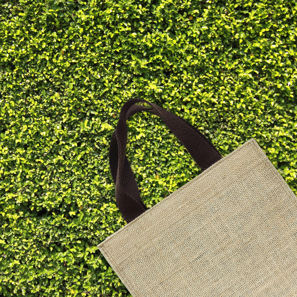 Shopping bag on green leaves - Φωτογραφία, εικόνα