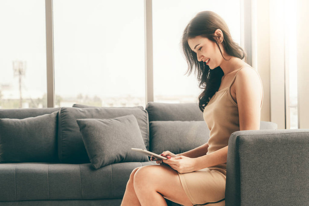 Beautiful business woman sitting on sofa in office - Photo, image