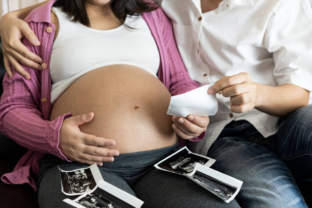 Pregnant couple feels love and relax at home. - Photo, Image