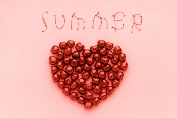 Red berry sweet cherries in shape of heart and text Summer of trendy coral shade, color of the year 2019 Template for postcard or your design Flat lay Top view - Photo, Image