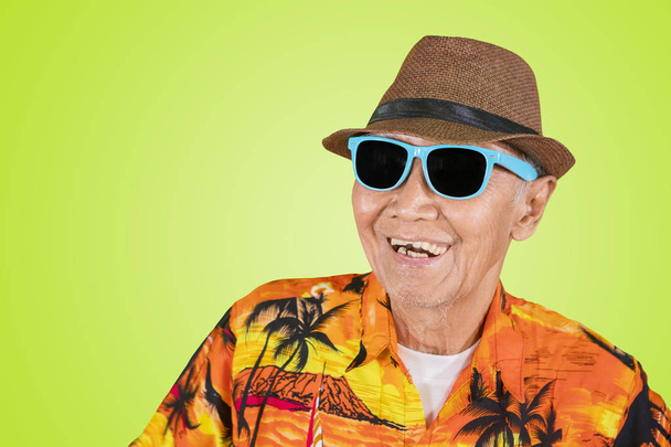 Happy old man wearing sunglasses on studio - Photo, Image
