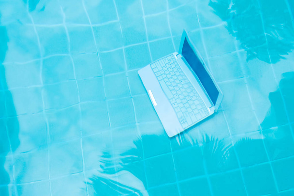 Přenosný počítač pod vodou. Minipočítač na dně bazénu. Koncept překážky v práci. Rozostřit abstraktní pozadí. - Fotografie, Obrázek