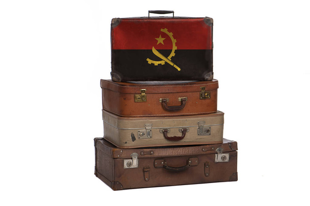 Angola, Angolan travel concept. Group of vintage suitcases isolated on white background. - 写真・画像