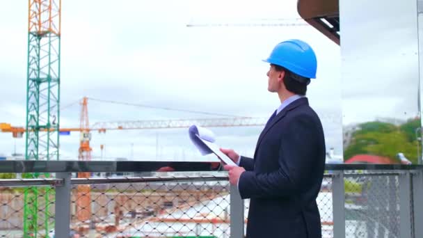 Real estate developer in helmet. New office construction. Confident businessman or architect in front of modern office building. - Footage, Video