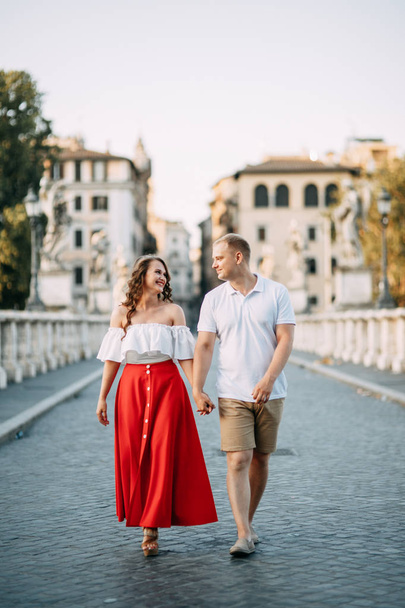 Stylish loving couple walking and laughing. Wedding shooting on the streets of Rome, Italy.  - Фото, изображение