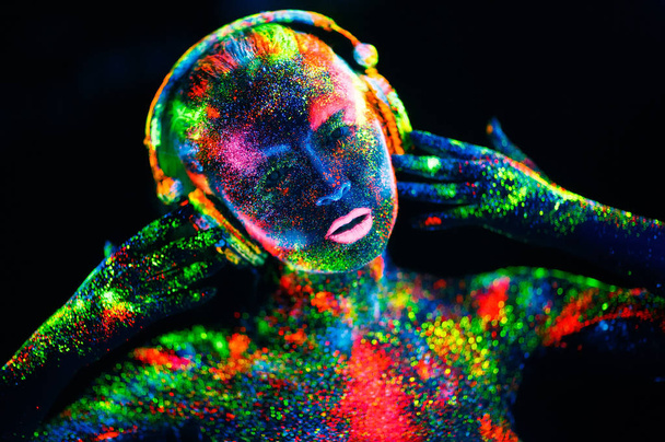 Concept. On the body of a girl painted DJ deck. Half-naked girl painted in UV colors - Foto, Imagem