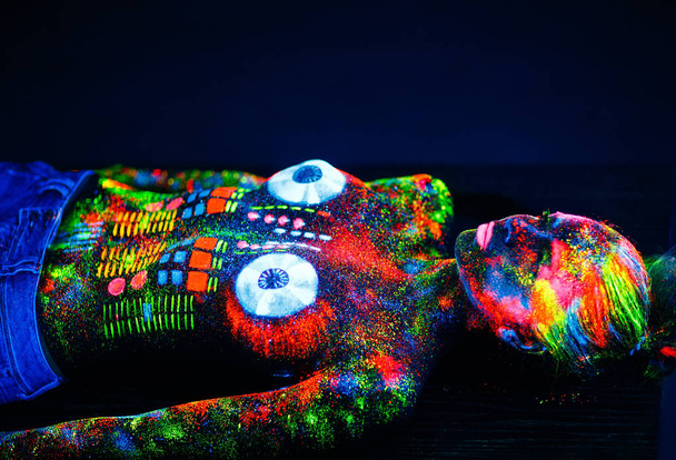 Concept. On the body of a girl painted DJ deck. Half-naked girl painted in UV colors. - 写真・画像