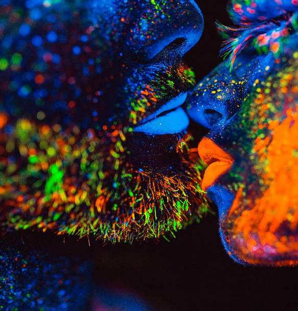 Portrait of a pair of lovers painted in fluorescent powder. - Photo, image