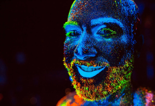 Portrait of a bearded man painted in fluorescent powder - Φωτογραφία, εικόνα