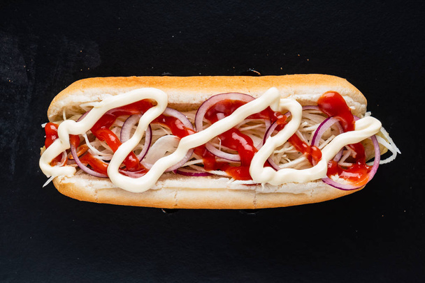 hot dog on the black background, close up - Foto, imagen