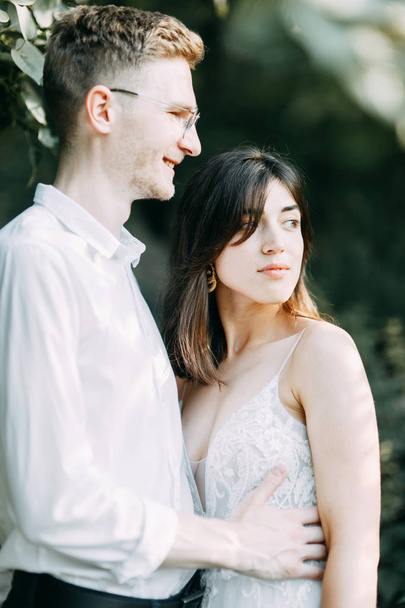 Happy couple outdoors at sunset. A stylish wedding in the European style of fine art.  - 写真・画像