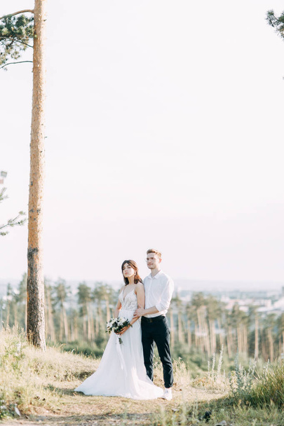 Happy couple outdoors at sunset. A stylish wedding in the European style of fine art.  - Photo, image