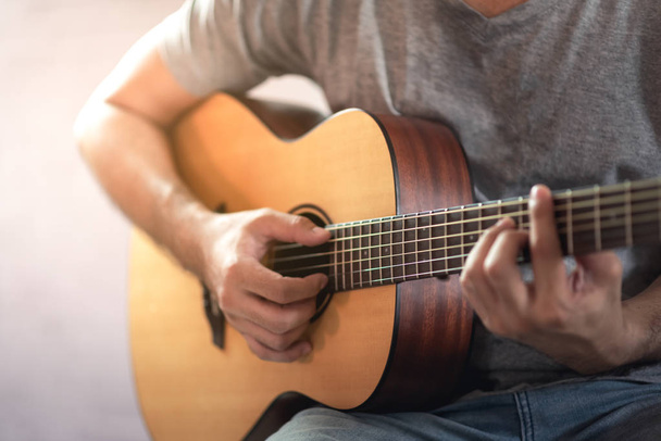 музикант грає на акустичній гітарі
 - Фото, зображення