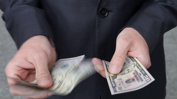 Businessman's hands counting dollars - Felvétel, videó