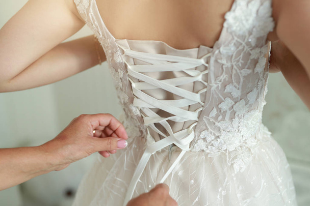 back of a beautiful wedding dress on the bride on the wedding day - 写真・画像