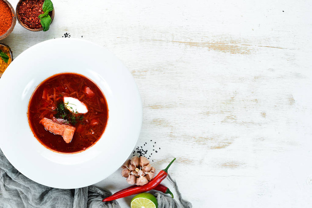 Borsch. Beet soup. Ukrainian cuisine. On a wooden background. Top view. Free space for your text. - Photo, image