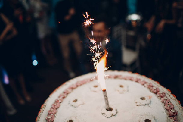 Festive cake and candle with sparks - Valokuva, kuva