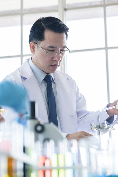 Asian senior scientist researching and learning in a laboratory. - Photo, Image
