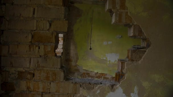 Through the hole in the wall of abandoned building, rotated point of view - Video, Çekim