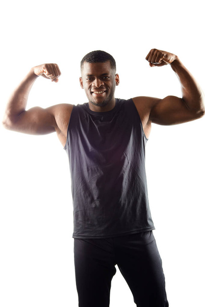 handsome guy in t-shirt with raised arms, showing his muscules - Photo, Image