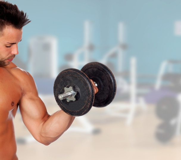 Muscled guy lifting weights - Foto, Imagem