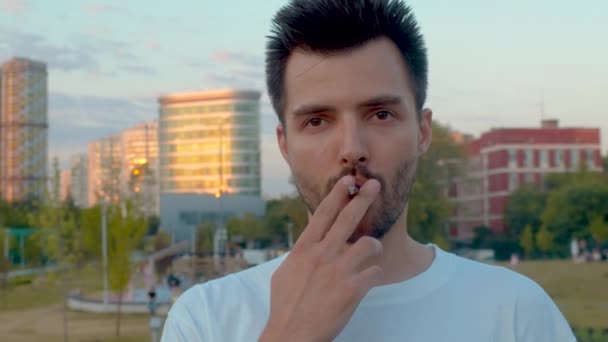 Portrait of a young man smoking - Video