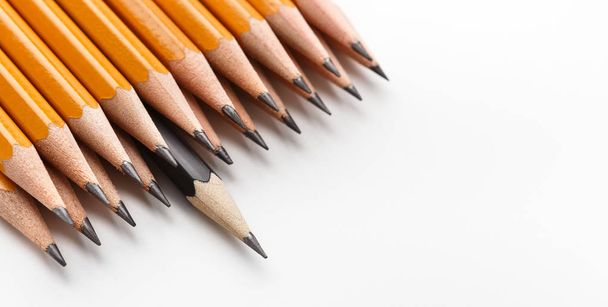 One black pencil among group of classic yellow ones - Photo, Image