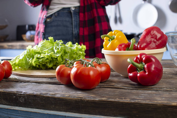 Tomaten, paprika en greens, liggen op een houten tafel, ingrediënten voor het maken van salade, close-up van gezonde voeding - Foto, afbeelding