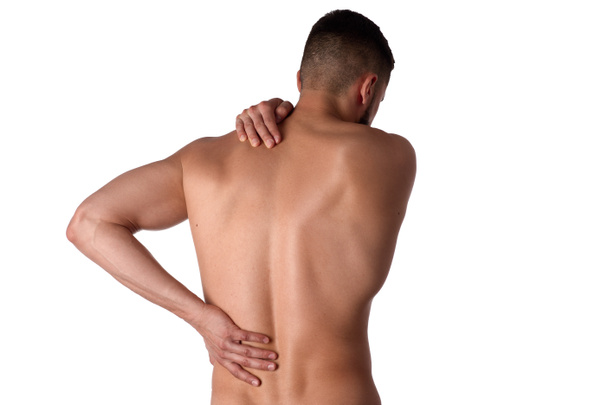 Young man with back pain. The athlete clings to a sore back. Man hurt his back. Sports medicine concept - Foto, imagen