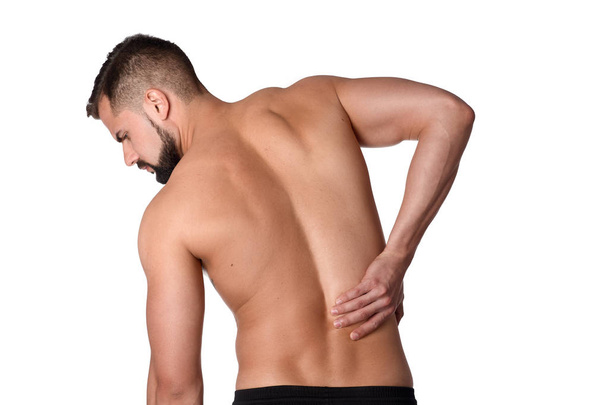 Fiatal férfi hátfájás. A sportoló ragaszkodik egy fájó vissza. Az ember fájt a hátán. Sportorvos fogalma - Fotó, kép