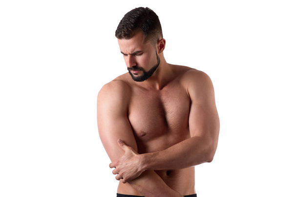 Svalnatý silný muž s bolestí na rameni, izolovaný na bílém pozadí. Sportovec má bolavé rameno - Fotografie, Obrázek