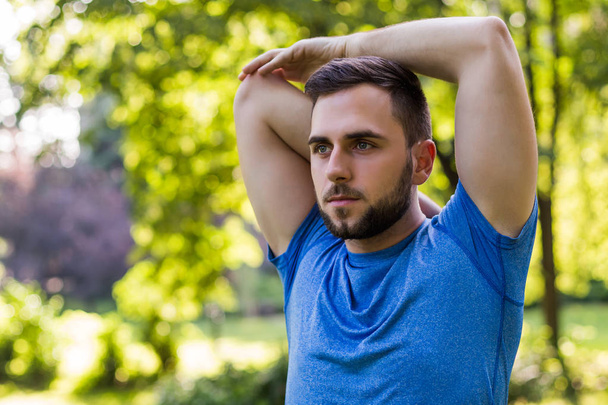 Handsome man exercising in the park. - 写真・画像