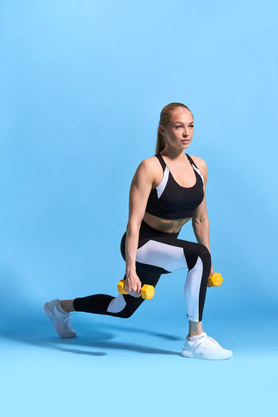 motivated strong sportswoman workig out in the sport studio - Foto, imagen