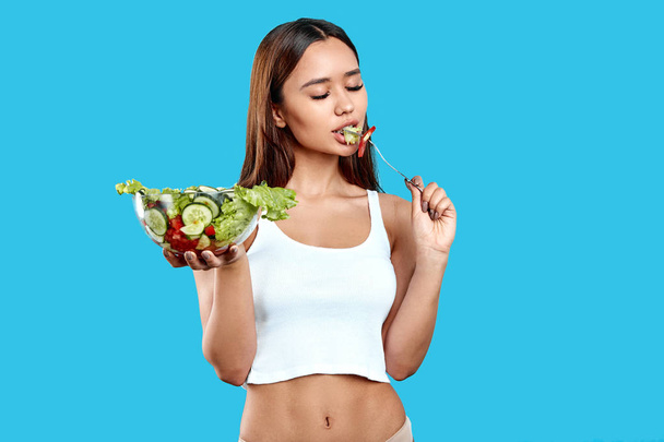 young beautiful girl gets plasure from eating healthy food - Photo, image
