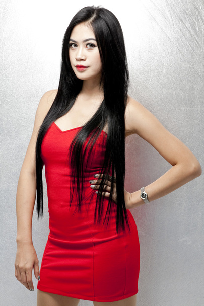 Sexy asian woman in beautiful red dress - 写真・画像