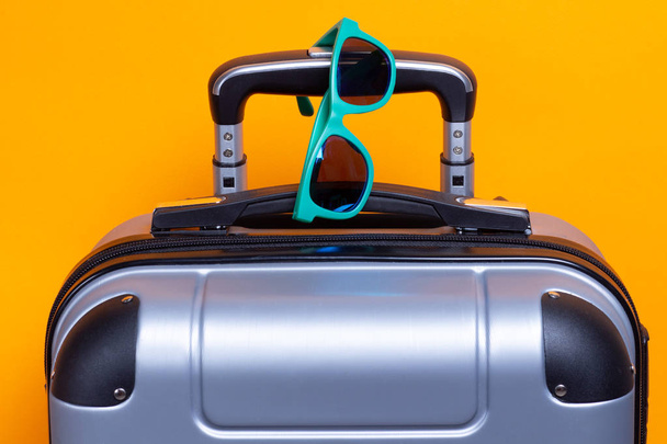 Summer sunglasses on suitcase. Travel and vacation concept - Zdjęcie, obraz
