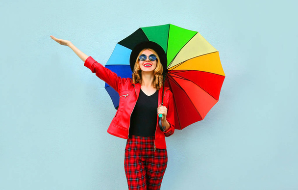 Happy smiling young woman holding colorful umbrella in hands, we - Foto, afbeelding