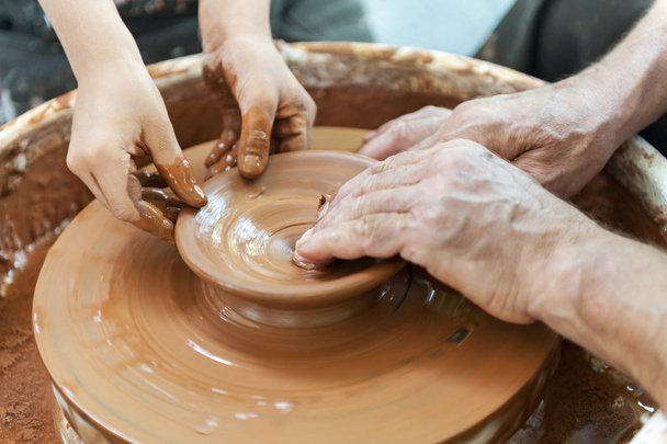 Handcrafted, Hands make clay. Master teaches the student to make - Foto, immagini