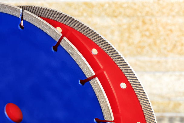 Diamond blades for granite and reinforced concrete against a background of orange-gold sandstone walls. - Photo, Image
