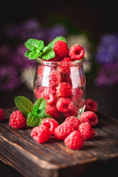 Raspberries in a Cup on a dark background. Summer and healthy food concept. Background with copy space. Selective focus. - Φωτογραφία, εικόνα
