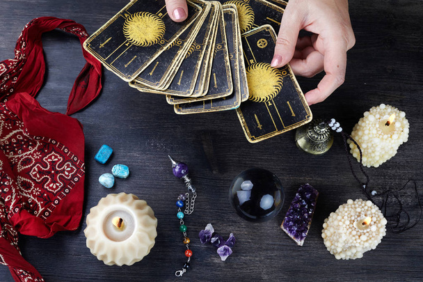 Fortune teller female hands and tarot cards on dark wooden table. Divination concept. - Φωτογραφία, εικόνα