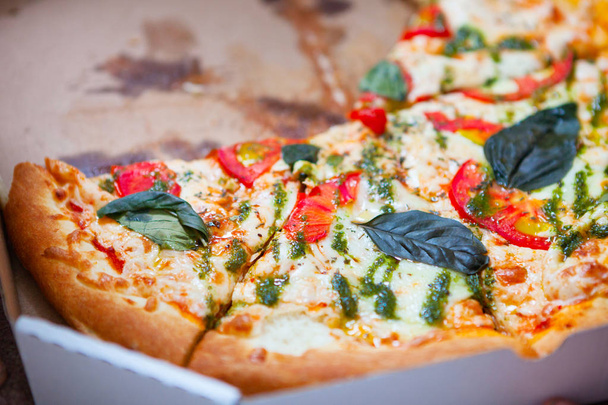Hot tasty italian pizza with vegetables in box on wooden backgro - Valokuva, kuva